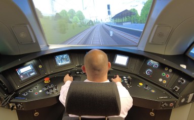 A man is sitting in front of a simulator.