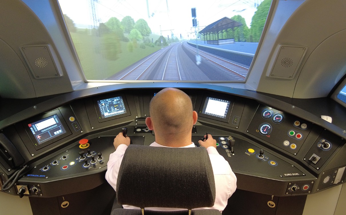 A man is sitting in front of a simulator,